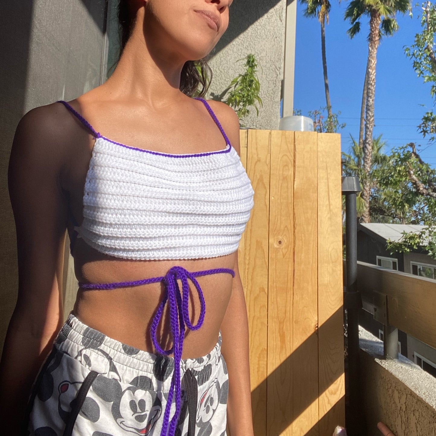 white crochet crop top with purple lining straps